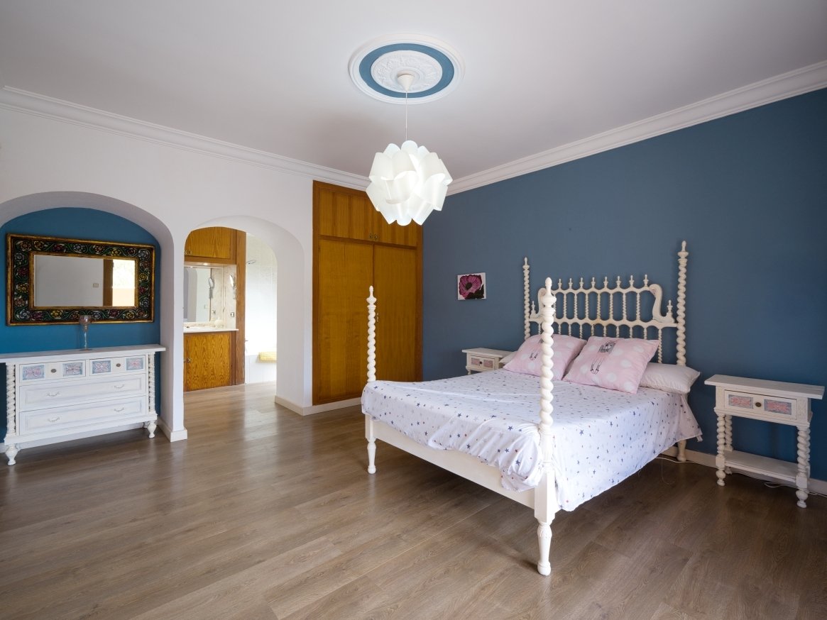 Spacious master bedroom with elegant layout and large window areas