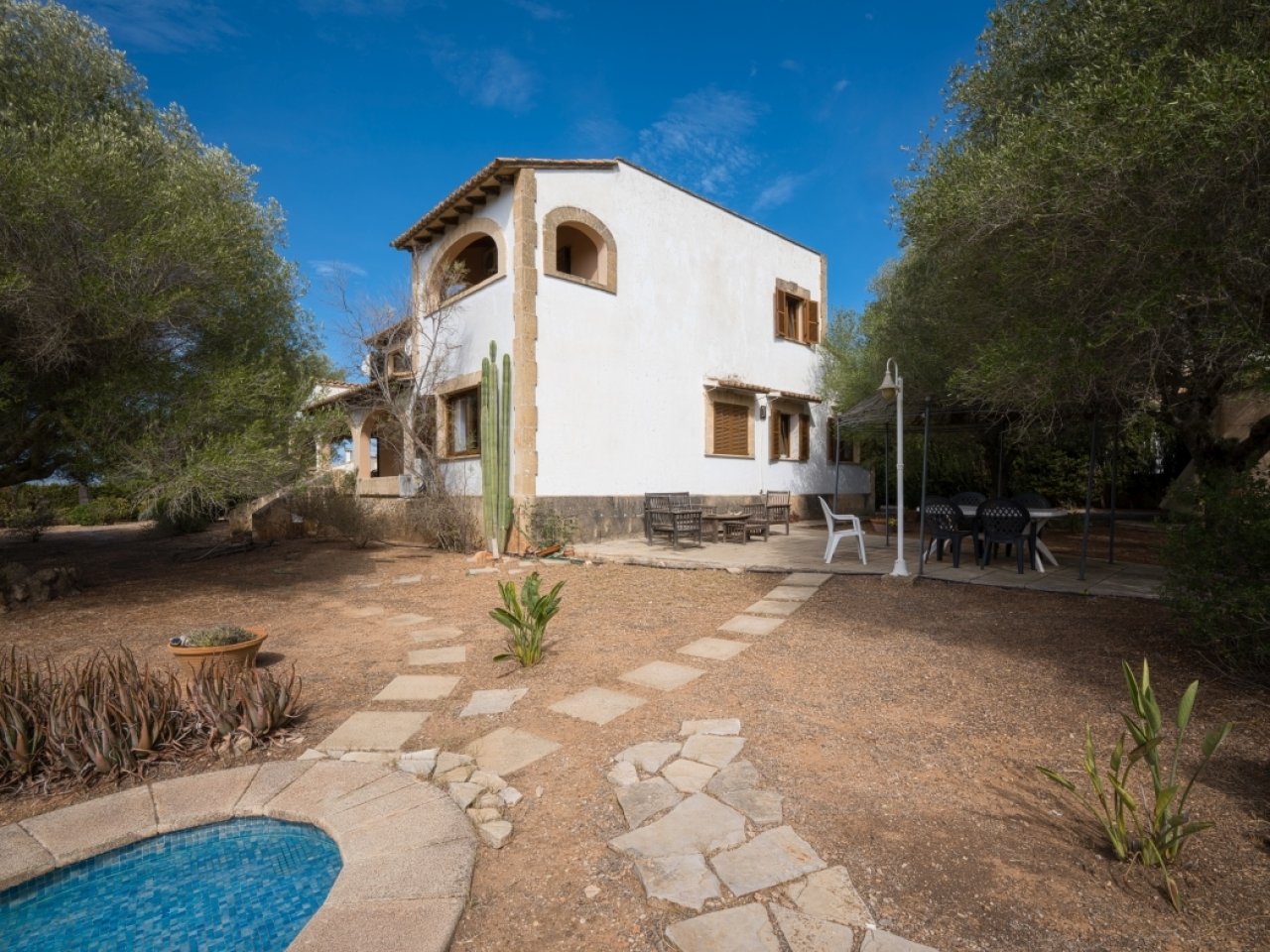 Mediterranean facade with distinctive archwork and spacious outdoor area
