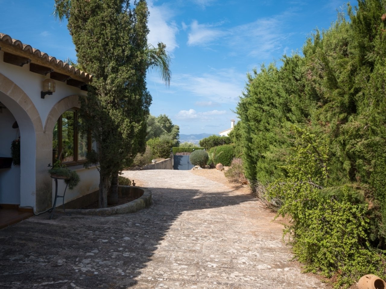 Well-maintained exterior with Mediterranean architecture and private driveway