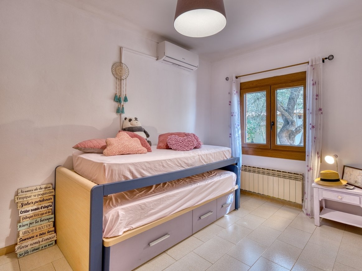 Children's room with a practical loft bed, storage space, and access to the terrace.