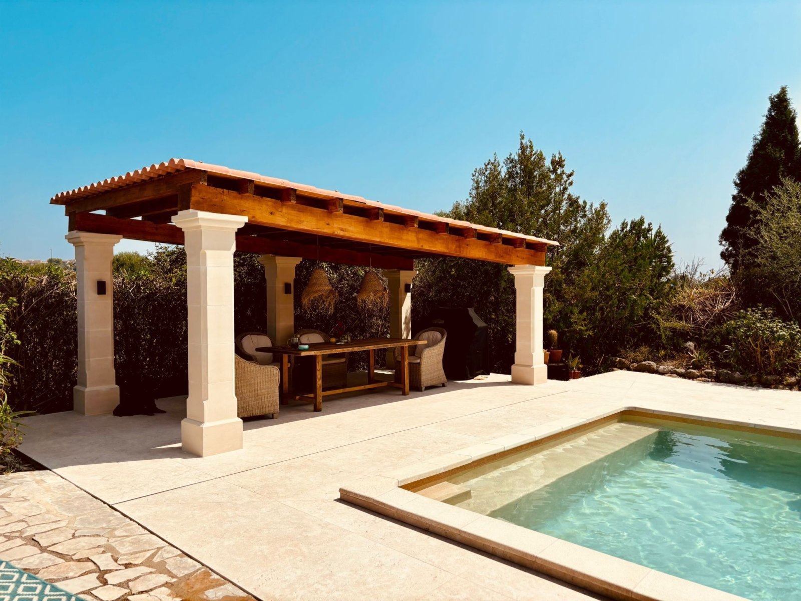 Covered lounge terrace with massive columns and direct pool access Covered lounge terrace with massive columns and direct pool access