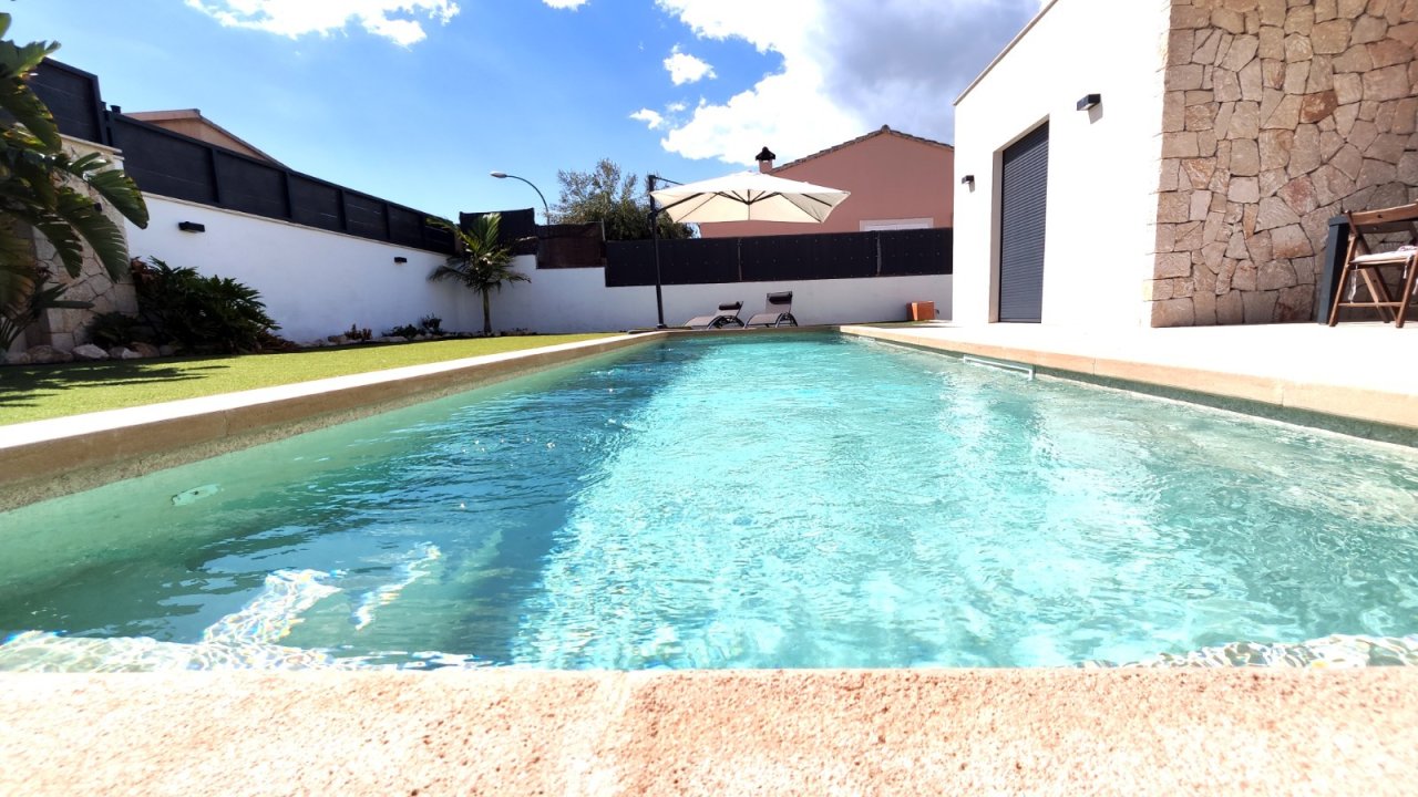 Refreshing swimming pool with a high-quality sandy beach entrance and extensively landscaped garden area