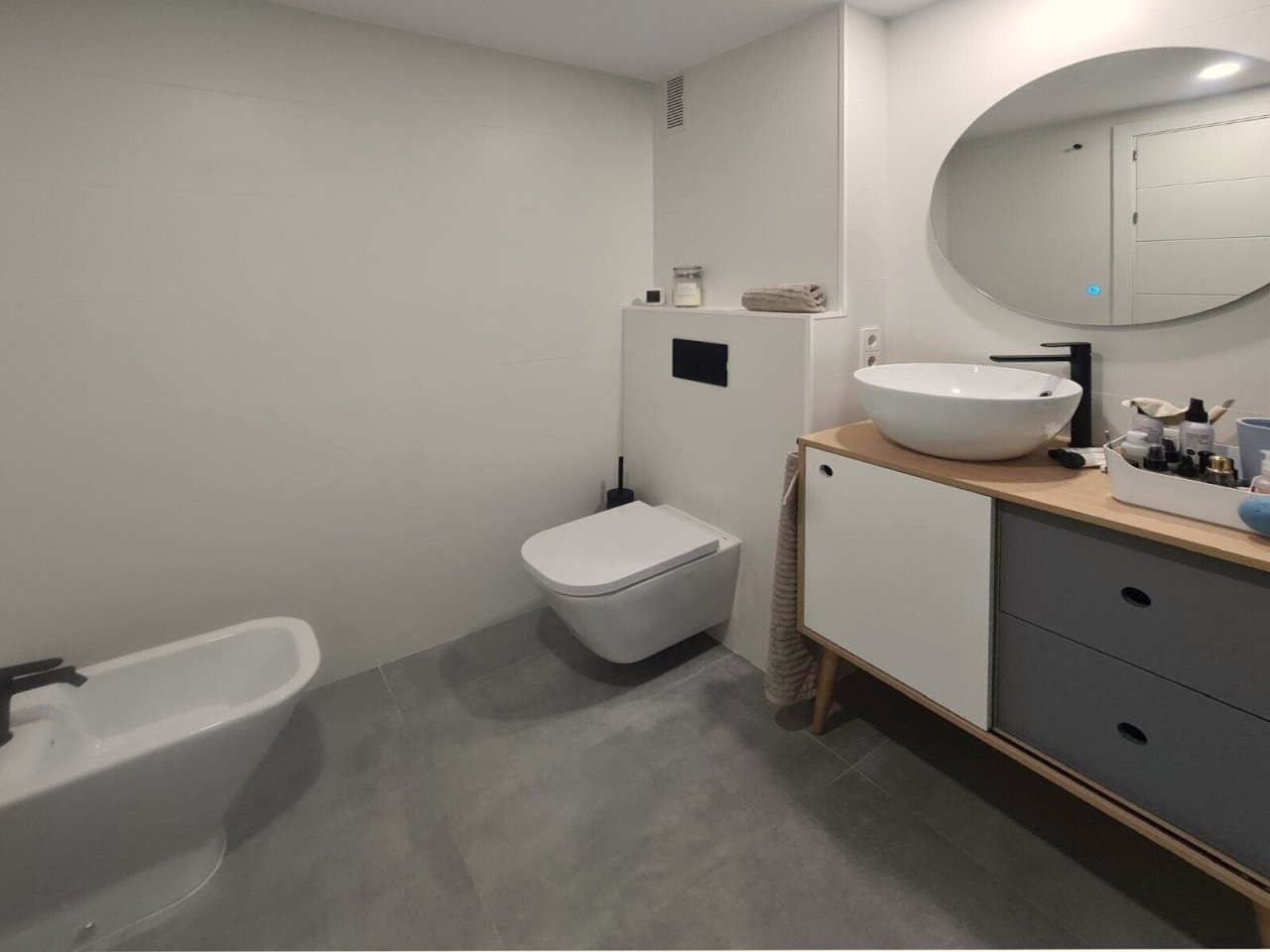 Modern bathroom with freestanding bathtub and elegant washstand.