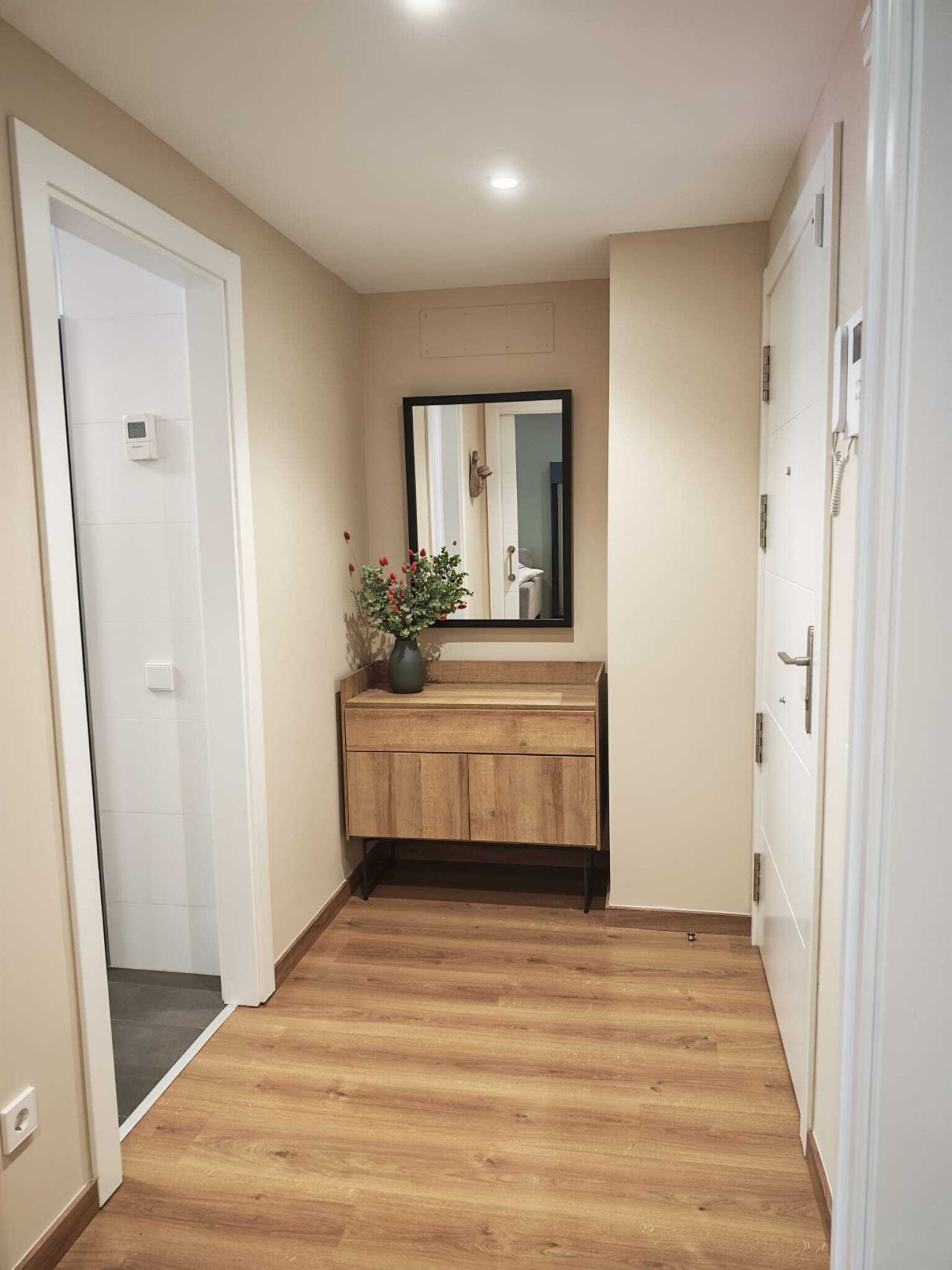 Elegant hallway area with practical coat rack and optimal layout