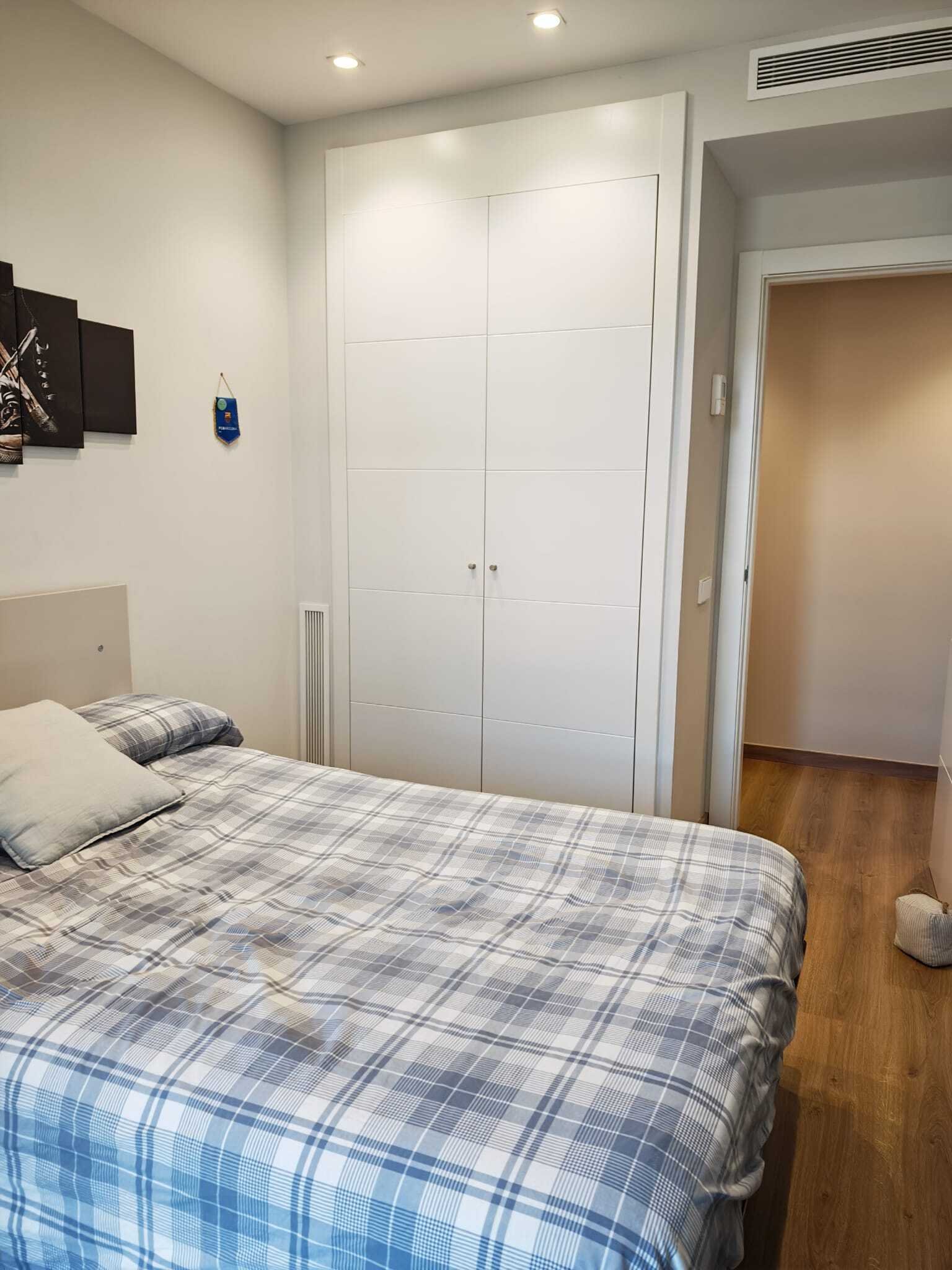 Bedroom with custom-built wardrobes and optimal space utilization