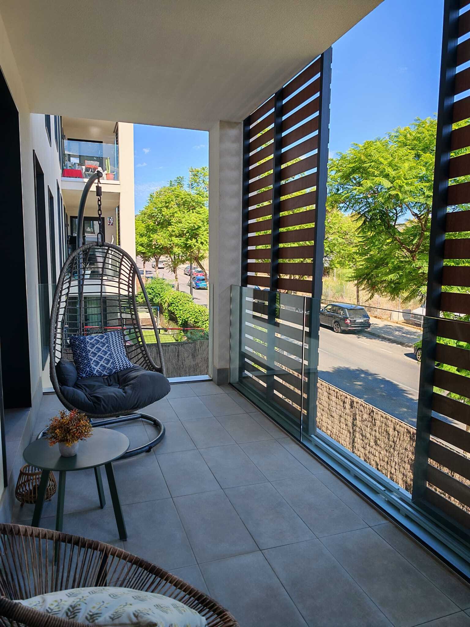 Private balcony with smart privacy system and direct view of green space