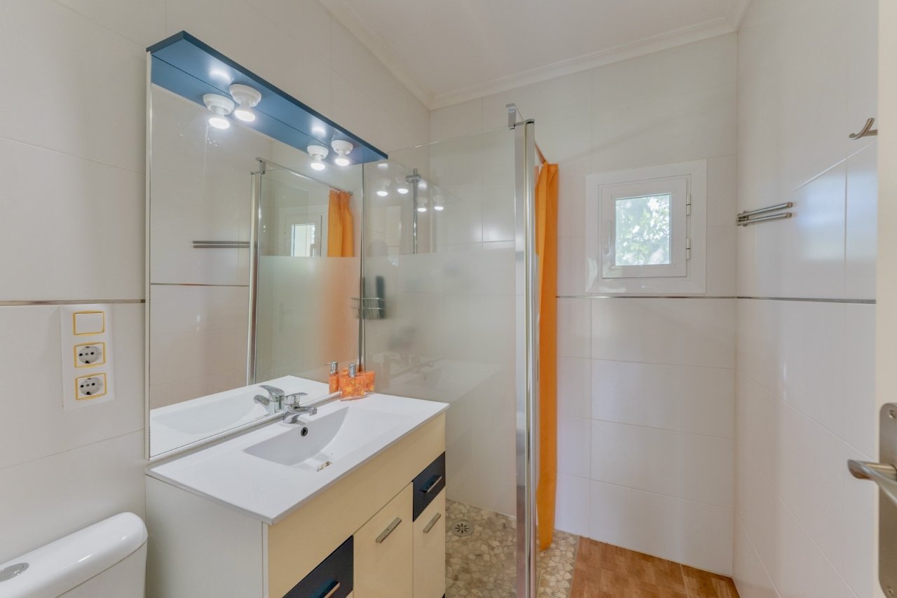 Modern bathroom with walk-in shower and smart storage solution Modern bathroom with walk-in shower and smart storage solution