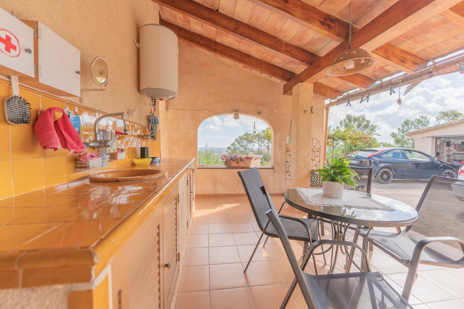 Open kitchen-living area with panoramic window and natural wooden beam ceiling – perfect for modern living with a view Open kitchen-living area with panoramic window and natural wooden beam ceiling – perfect for modern living with a view