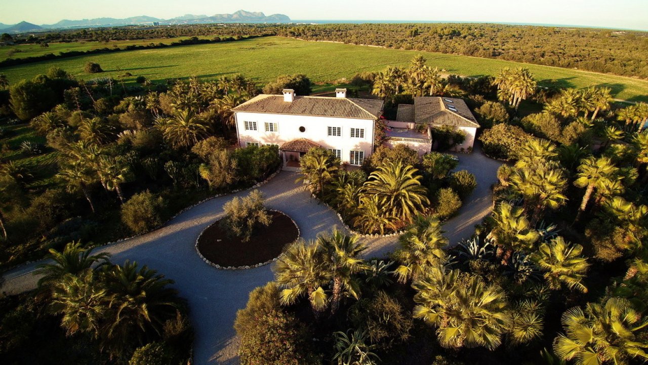 Aerial view: stately estate with extensive park grounds and mountain panorama