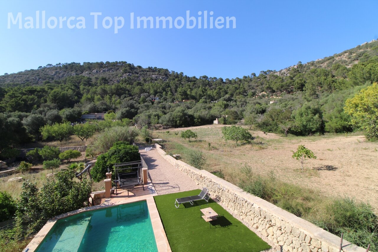 Pool area with natural stone wall and spacious open space for relaxing