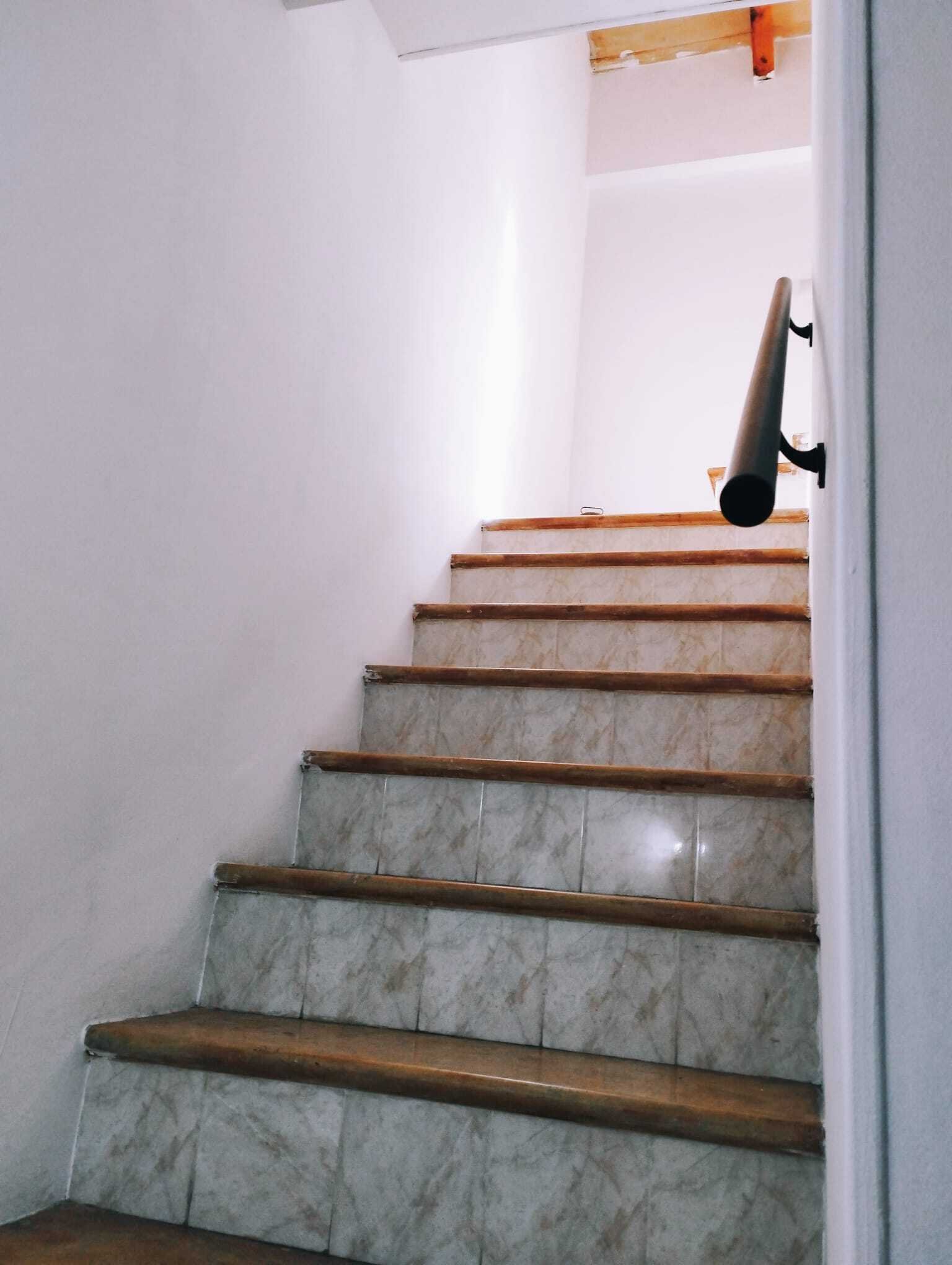 Elegant staircase with marble steps and solid wood railing