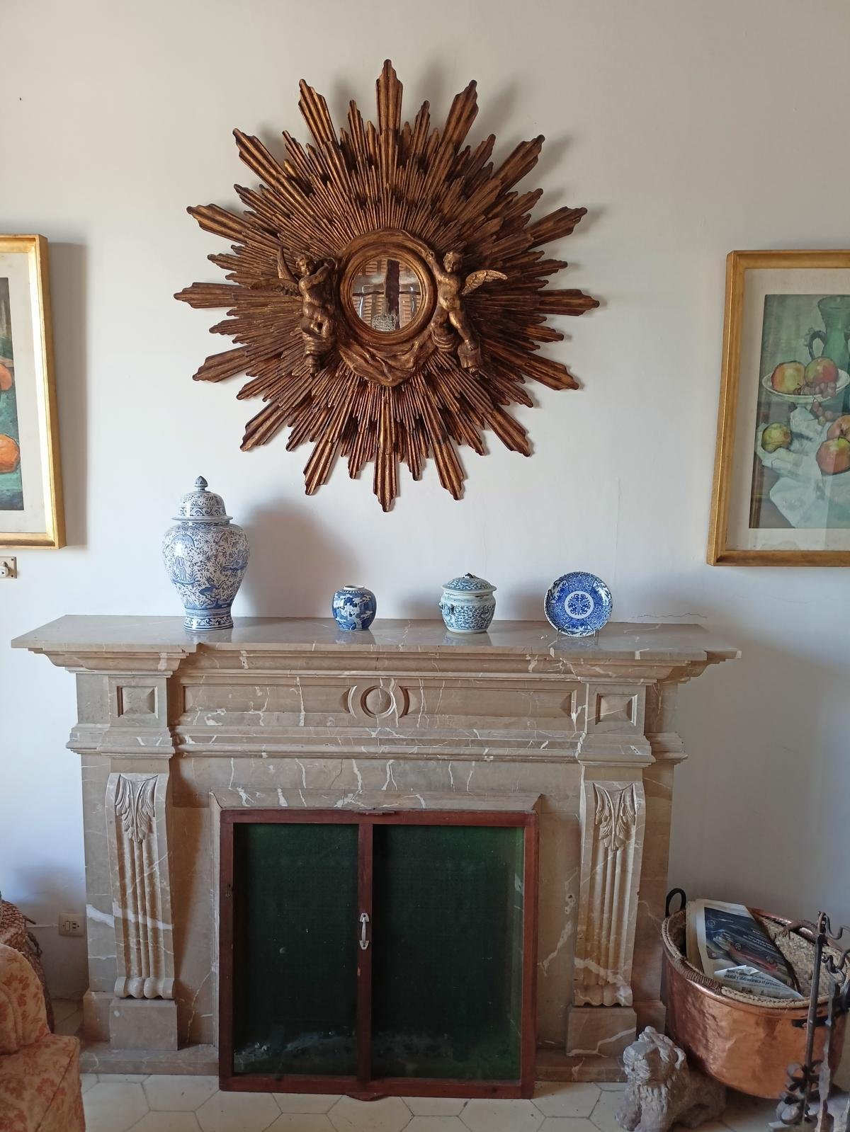 Elegant fireplace room with an elaborately decorated marble fireplace and decorative niches.
