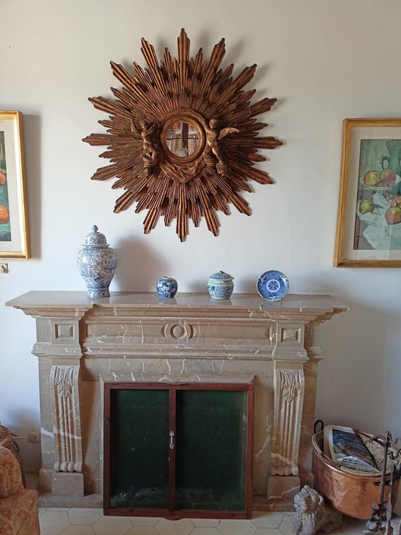 Elegant fireplace room with an elaborately decorated marble fireplace and decorative niches.