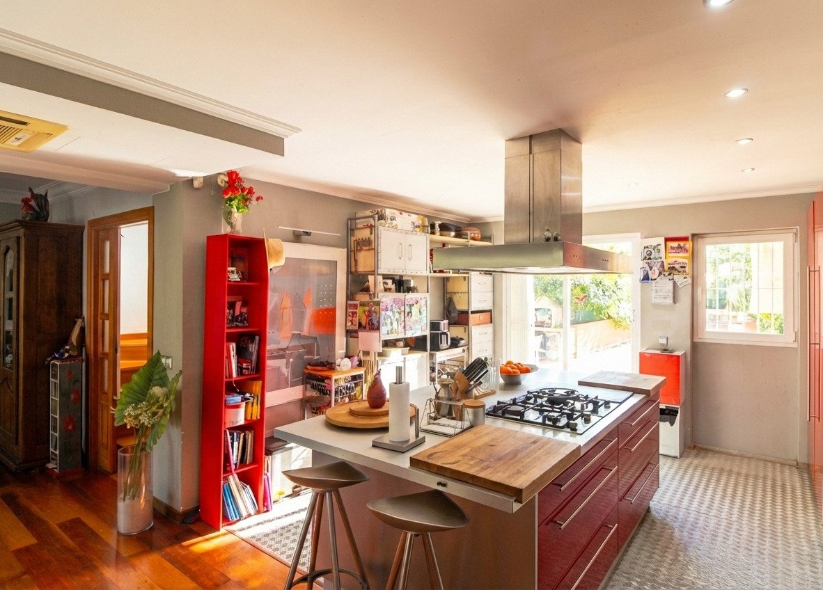 Modern kitchen with a central island, high-quality built-in appliances, and a professional extractor system