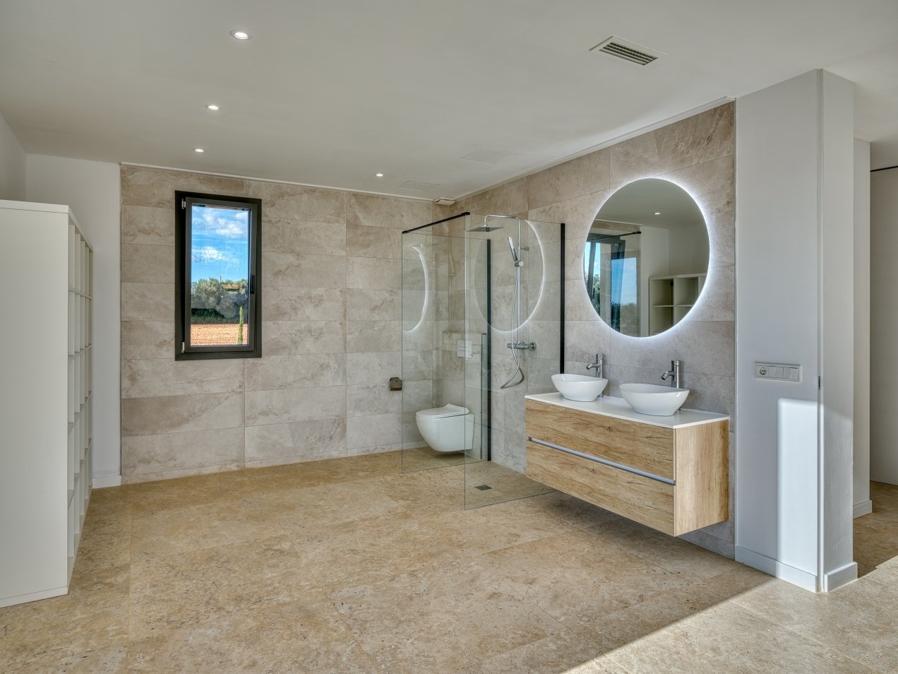 Modern spa bathroom with LED mirror system, walk-in shower, and panoramic window