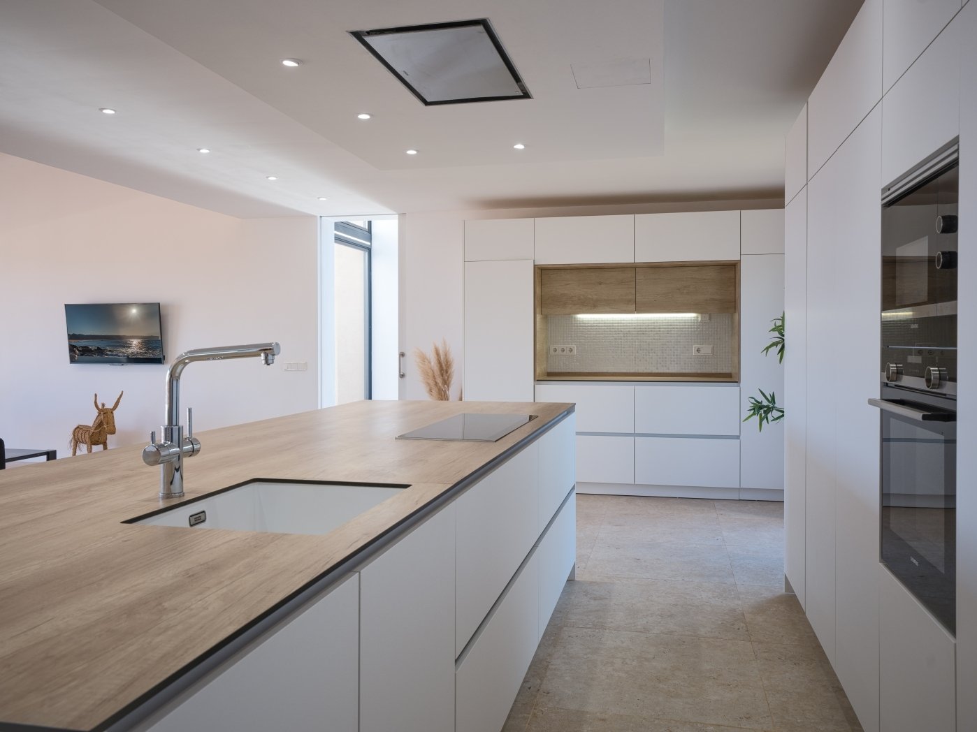 Modern kitchen with central cooking area and high-quality built-in appliances
