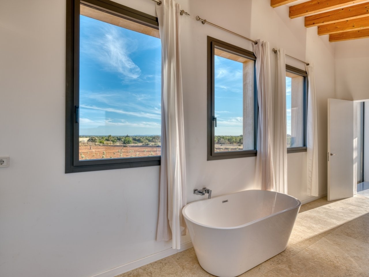 Luxurious bathroom with freestanding bathtub and panoramic view of the landscape