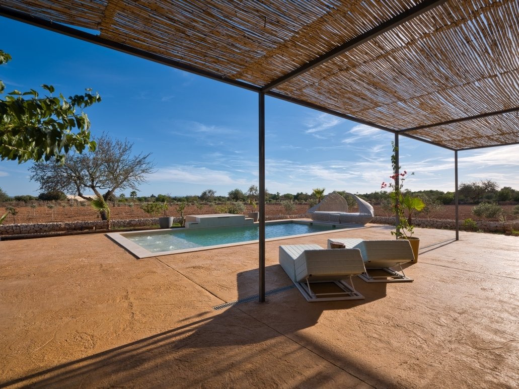 Pool area with shaded lounge zone and spacious open space