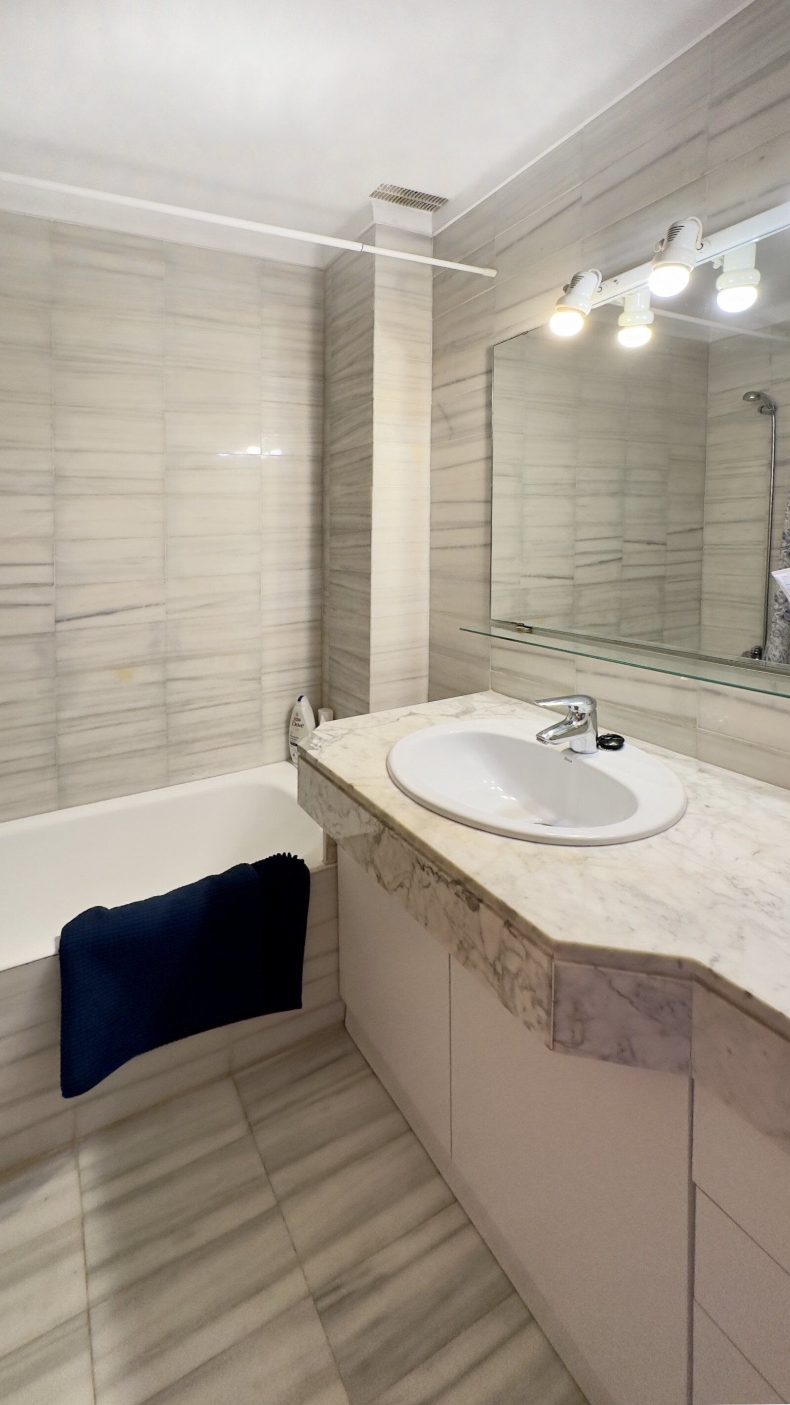 Modern bathroom with walk-in shower and marble washbasin – high-quality sanitary fittings and level shower area