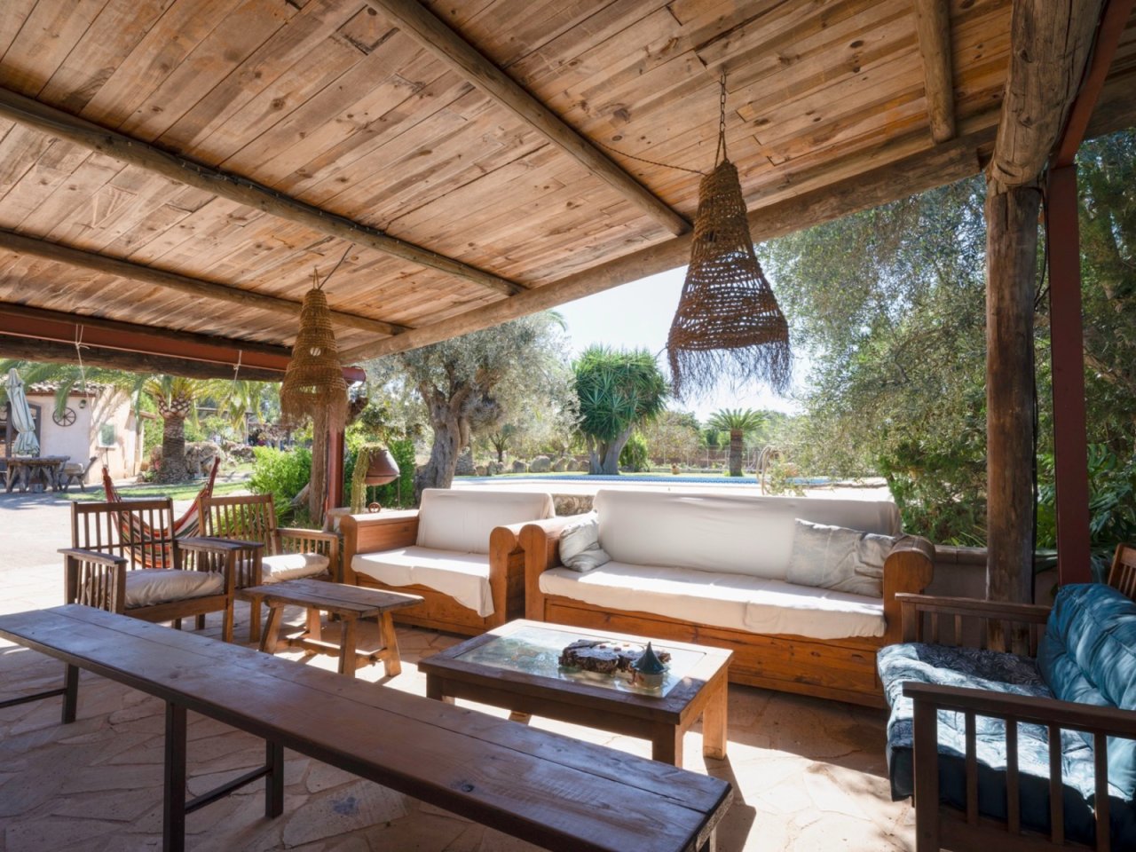 Shady relaxing oasis: pergola with solid wooden beams and open pool view Shady relaxing oasis: pergola with solid wooden beams and open pool view
