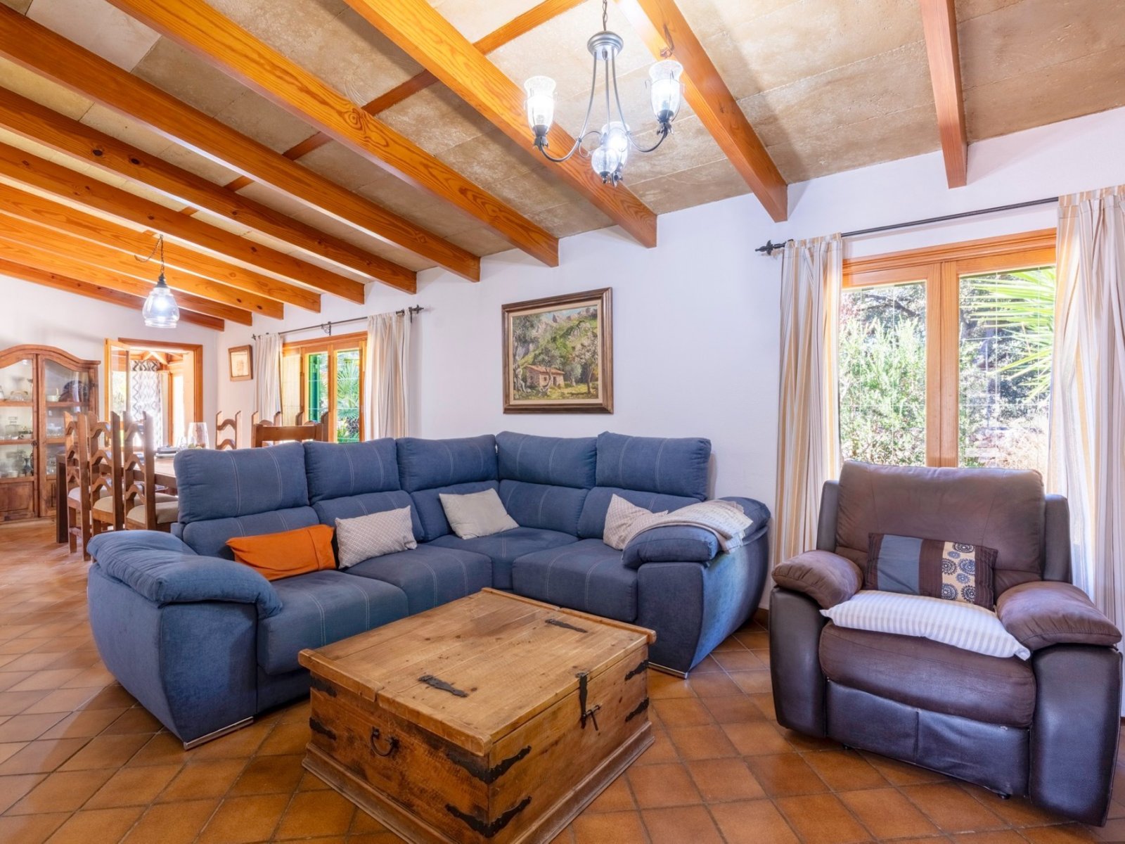 Living room with characterful wooden beams and large terrace windows Living room with characterful wooden beams and large terrace windows
