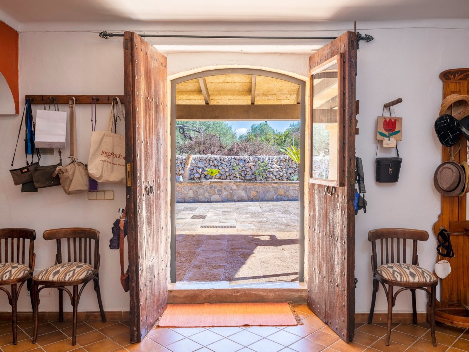 Welcoming entrance area with rustic wooden doors and an open view of the terrace Welcoming entrance area with rustic wooden doors and an open view of the terrace