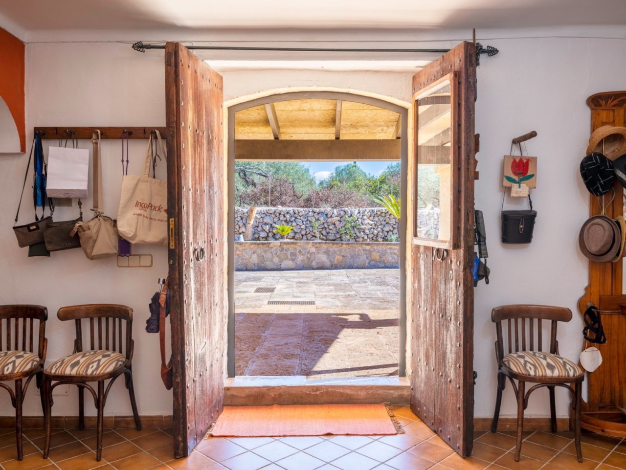 Welcoming entrance area with rustic wooden doors and an open view of the terrace Welcoming entrance area with rustic wooden doors and an open view of the terrace