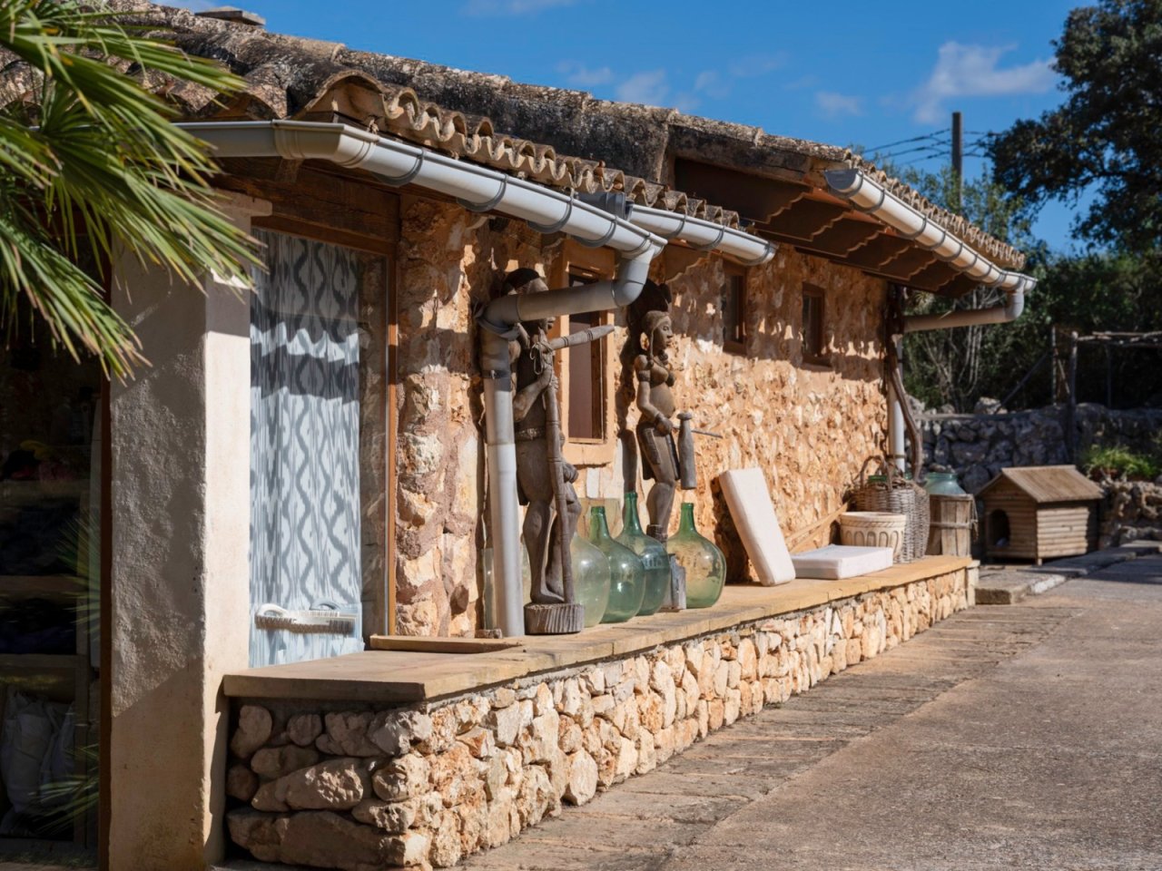 Rustic natural stone facade with a distinctive roof overhang and modern drainage system Rustic natural stone facade with a distinctive roof overhang and modern drainage system