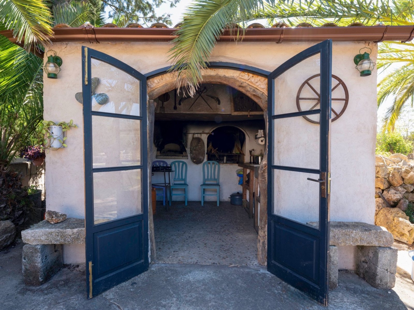 Charming entrance with distinctive double doors and a rustic stone arch. Charming entrance with distinctive double doors and a rustic stone arch.