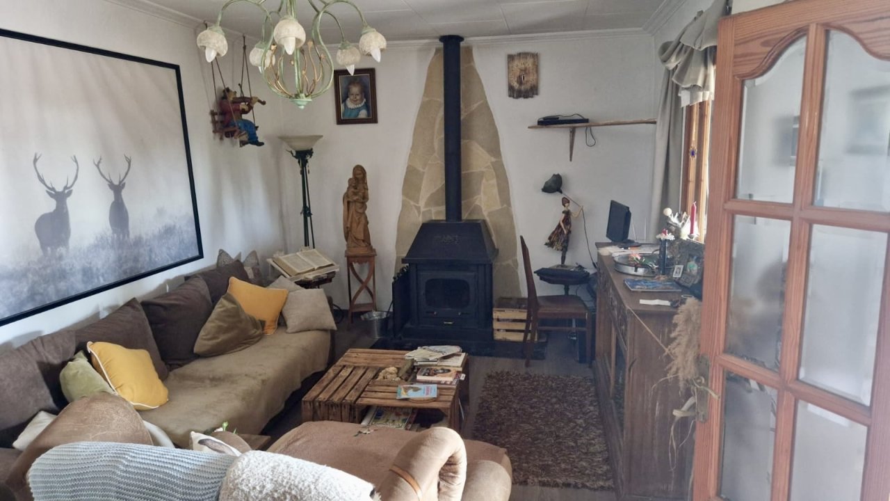 Cozy living room with fireplace and direct access to the terrace