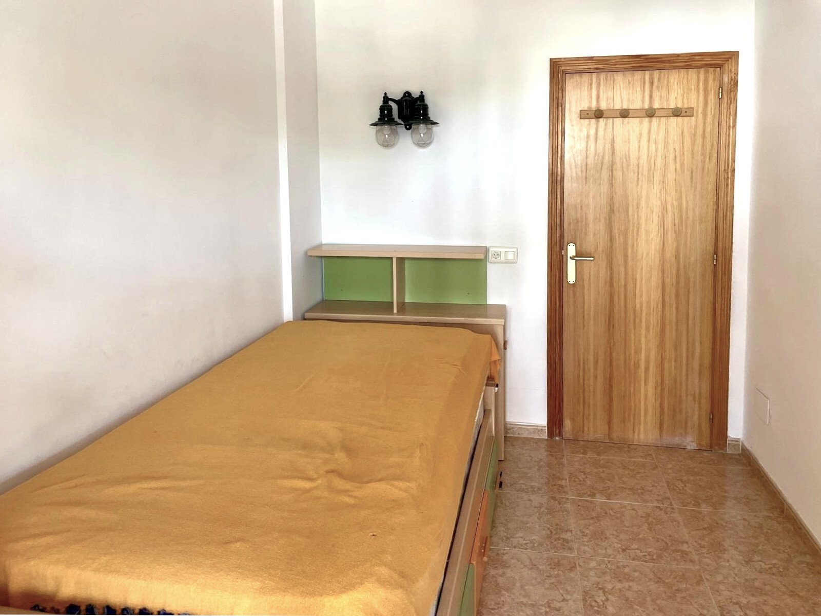 Functional bedroom with practical built-in wardrobes and high-quality wooden door Functional bedroom with practical built-in wardrobes and high-quality wooden door