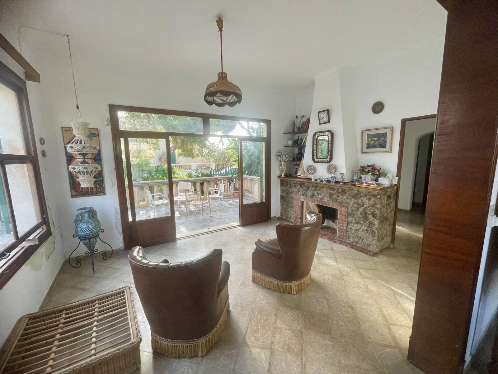 Elegant living room with fireplace and large glass sliding doors to the outdoor area Elegant living room with fireplace and large glass sliding doors to the outdoor area