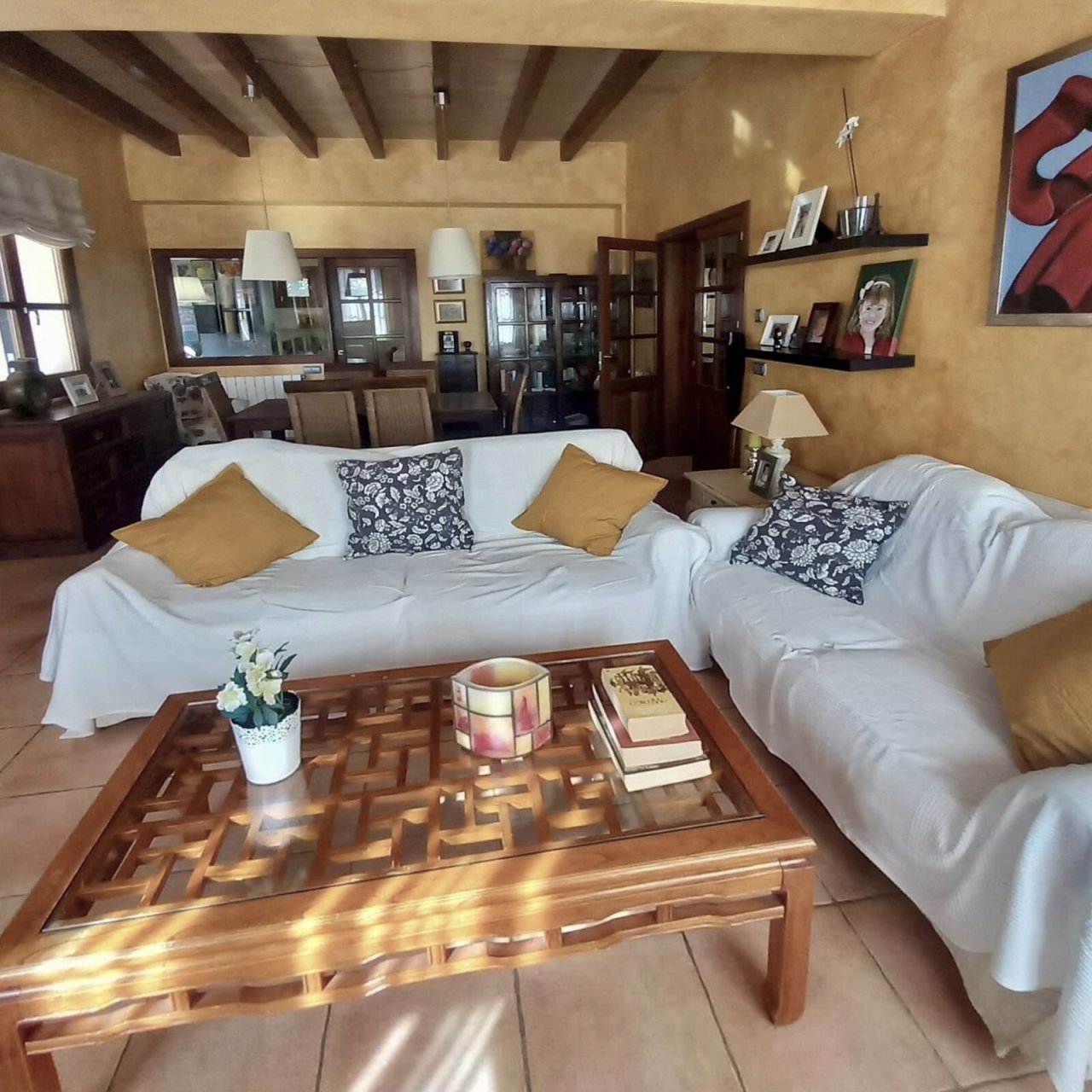 Open living concept with exposed beam ceiling and flowing room transitions