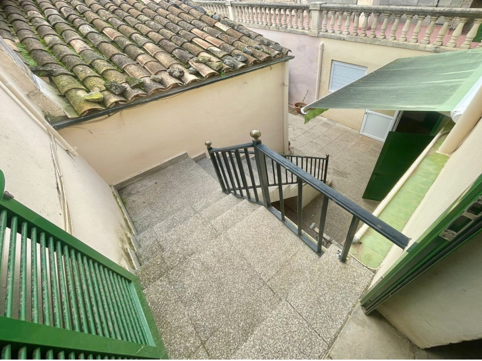 Terraced outdoor area with secure staircase and covered access