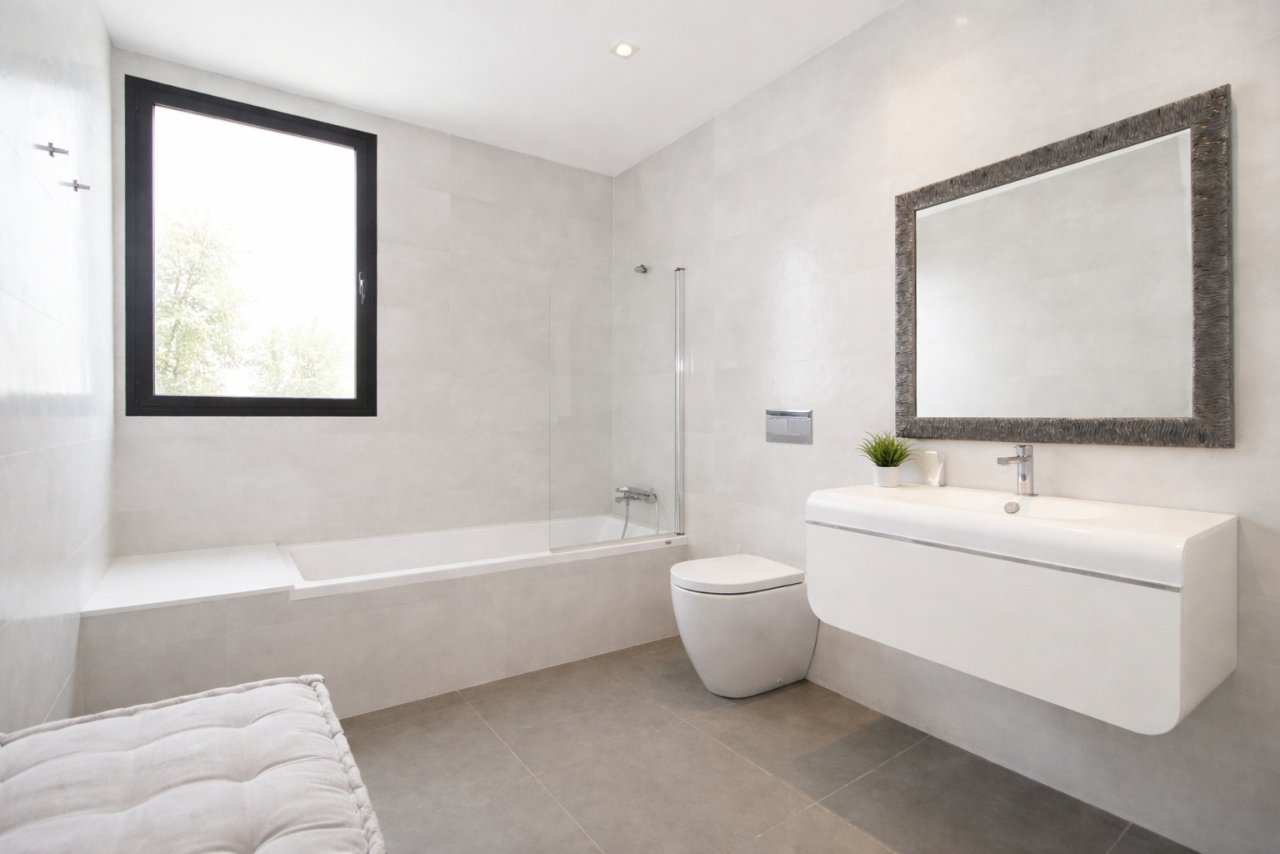 Modern bathroom with bathtub, walk-in shower, and ample natural light from windows