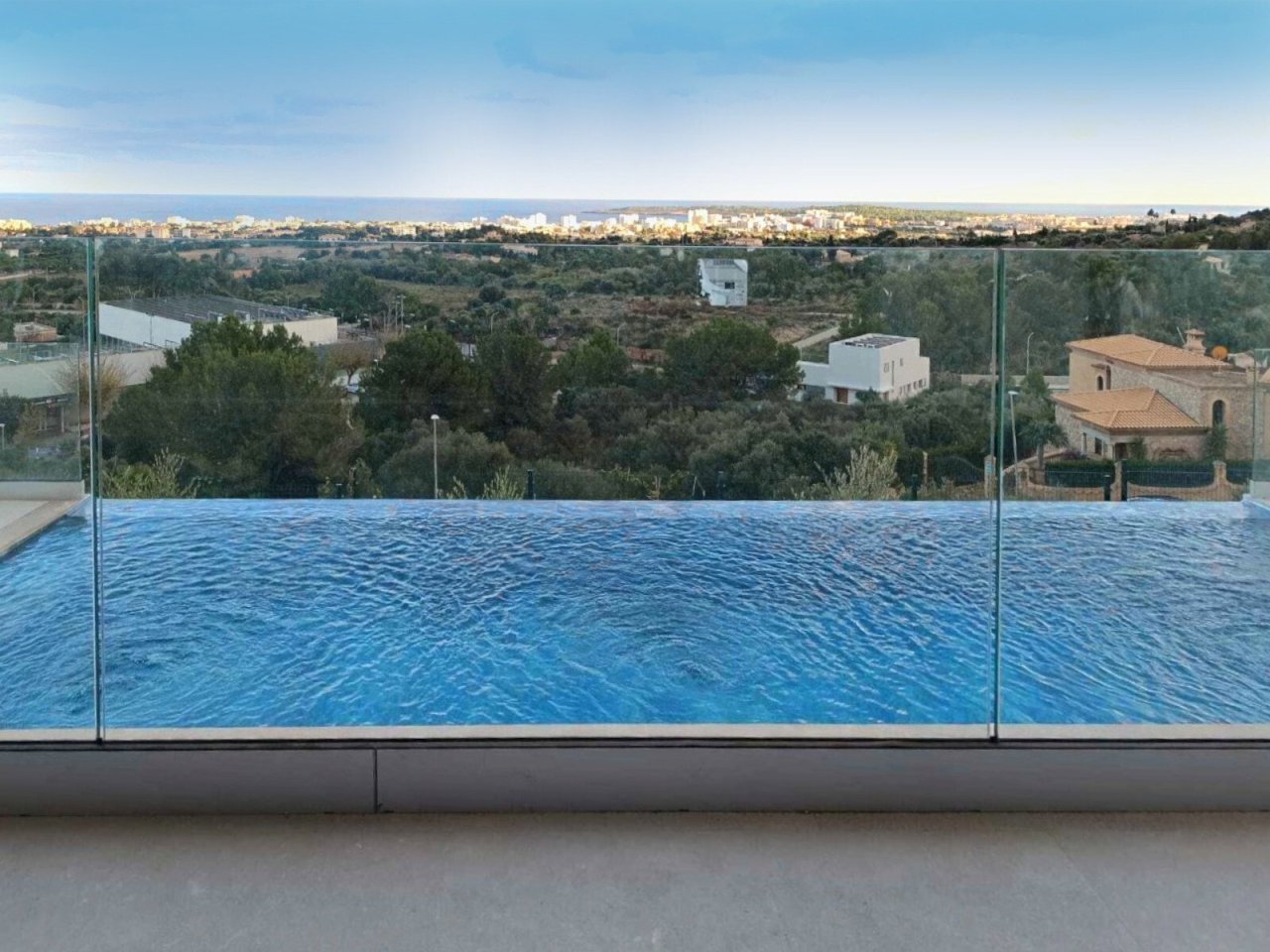Infinity pool with panoramic view of landscape and sea Infinity pool with panoramic view of landscape and sea