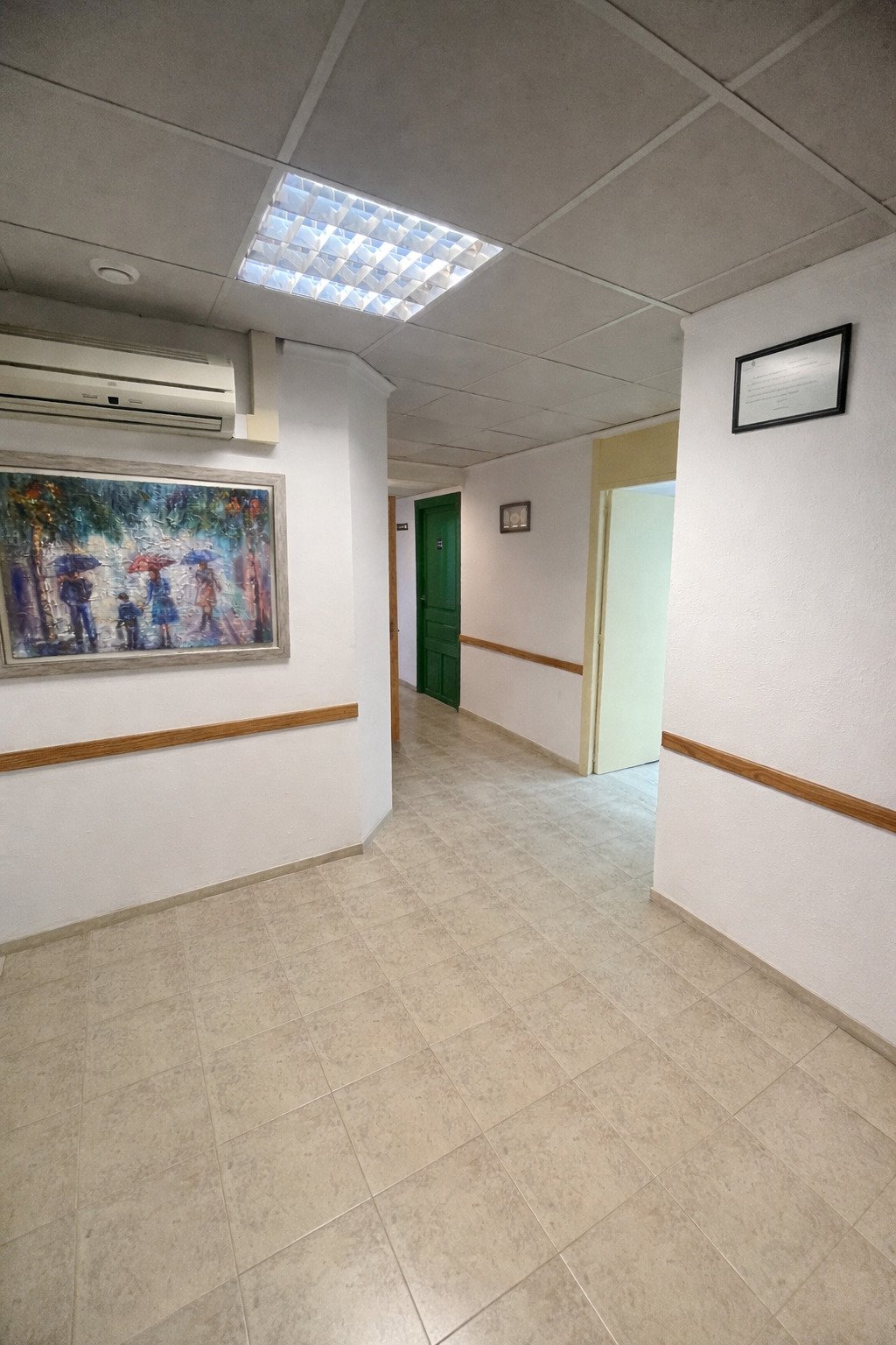 Bright corridor area with modern LED ceiling lighting and practical room layout.