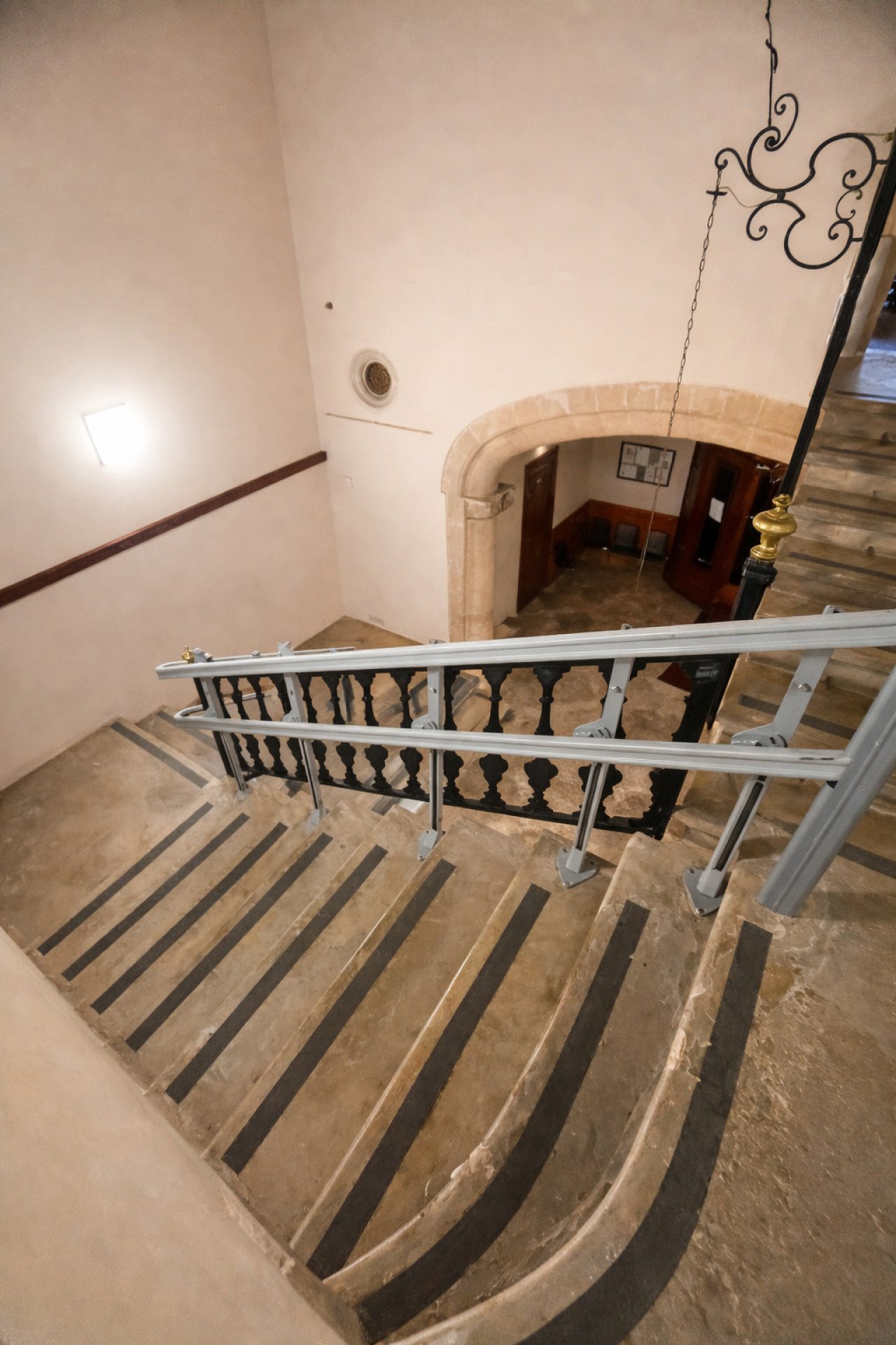 Elegant staircase with authentic stone arch architecture and a classic balustrade