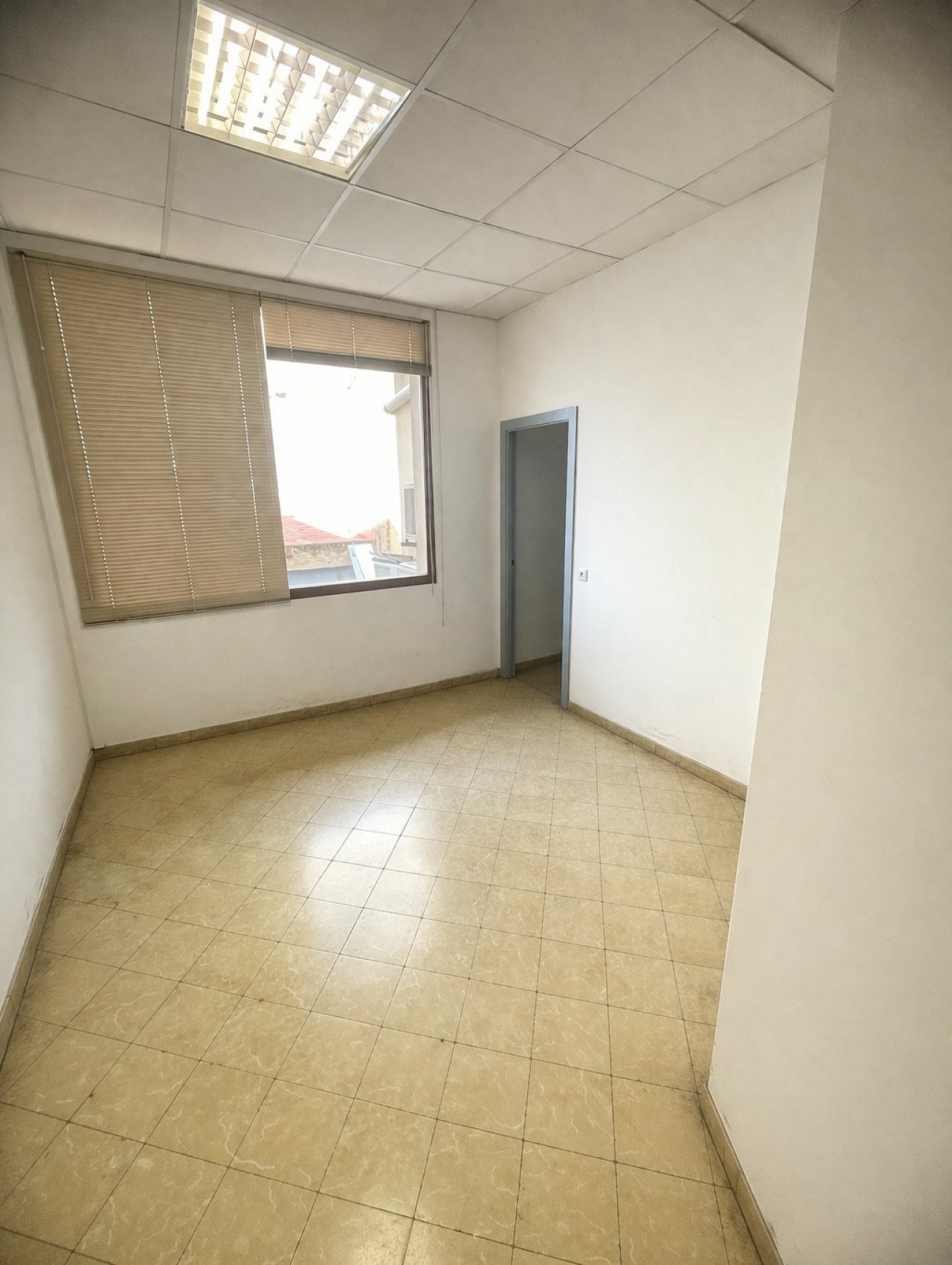 Bright office room with large window and practical layout