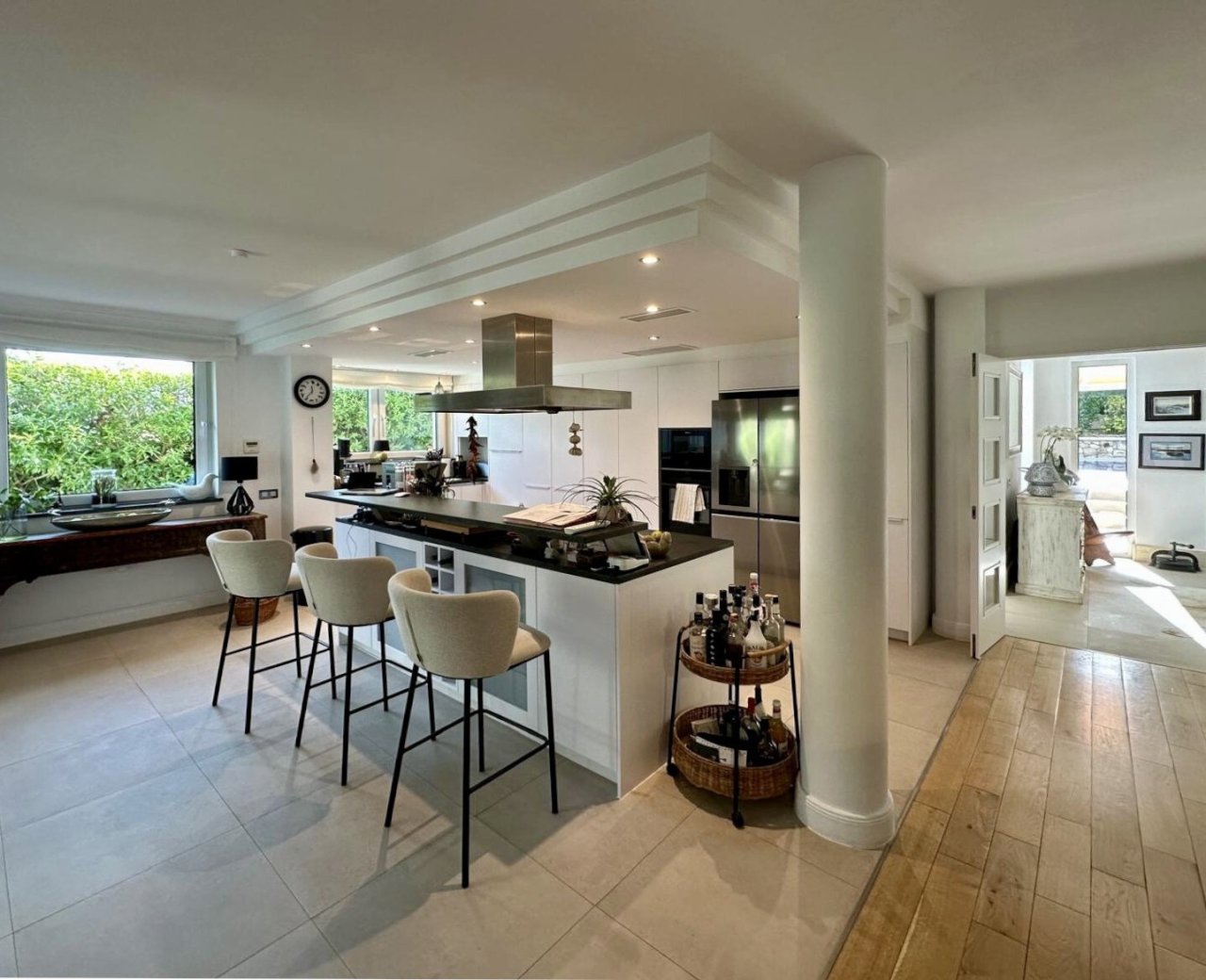 Kitchen with a central island, integrated dining counter, and professional exhaust system – well-designed workspace for modern cooking Kitchen with a central island, integrated dining counter, and professional exhaust system – well-designed workspace for modern cooking