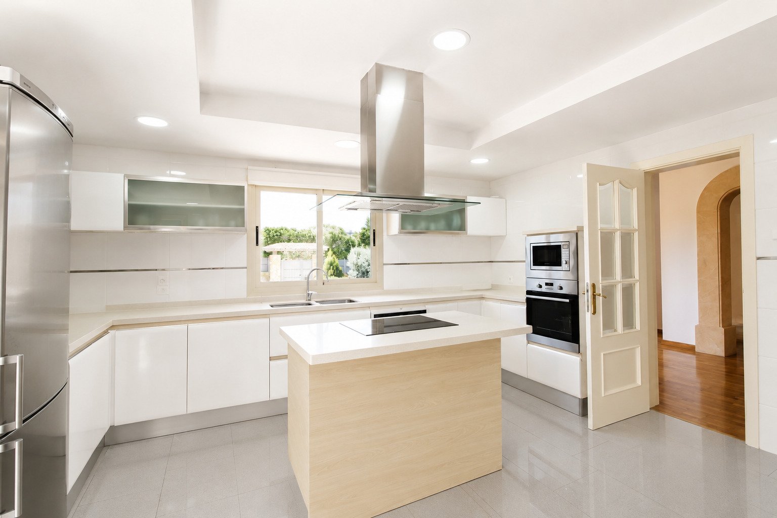 Modern kitchen with central island and professional exhaust system Modern kitchen with central island and professional exhaust system