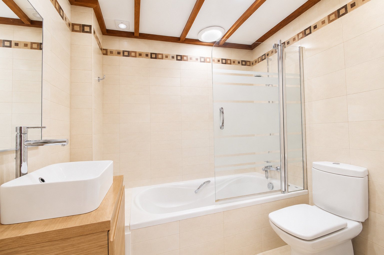 Luxurious bathroom with freestanding tub, walk-in glass shower, and ceiling beam accents Luxurious bathroom with freestanding tub, walk-in glass shower, and ceiling beam accents