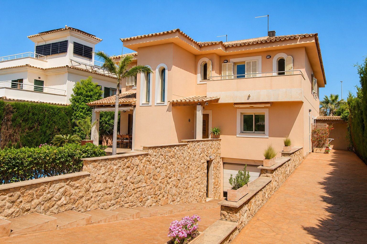 Mediterranean outdoor area with paved driveway and structured terrace design Mediterranean outdoor area with paved driveway and structured terrace design