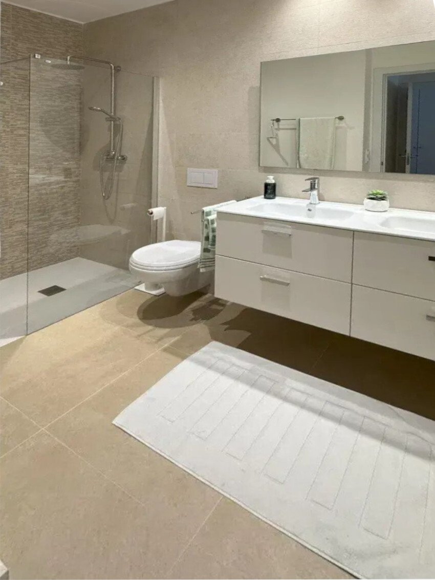 Modern bathroom with double sink, walk-in shower, and ample storage space Modern bathroom with double sink, walk-in shower, and ample storage space