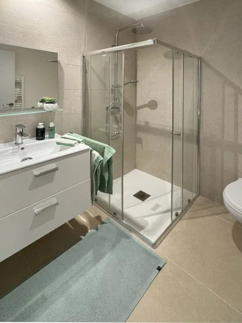 Modern bathroom with walk-in shower, double vanity, and heater Modern bathroom with walk-in shower, double vanity, and heater