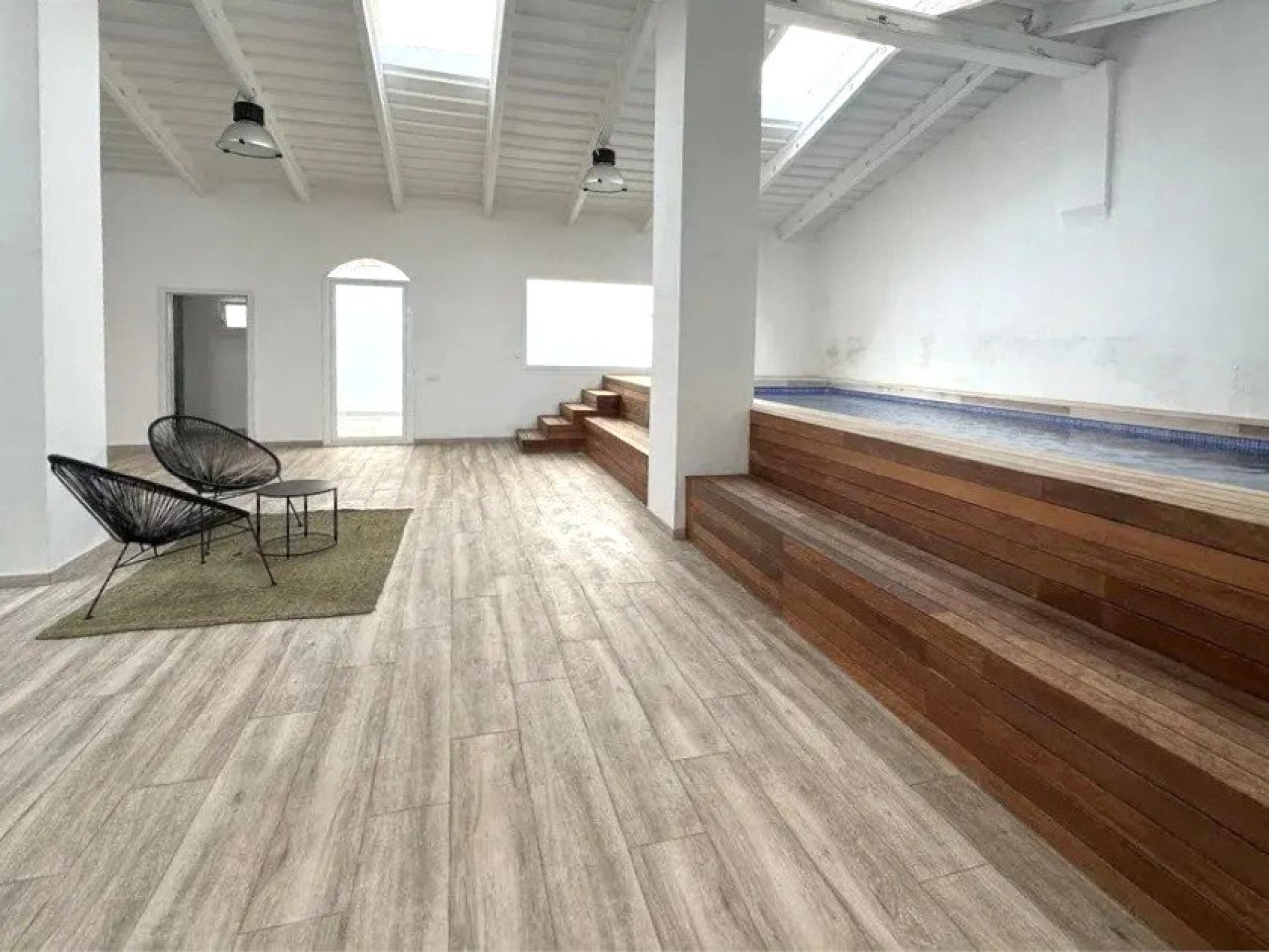 Loft area with skylights, exposed beam ceiling, and open floor plan Loft area with skylights, exposed beam ceiling, and open floor plan