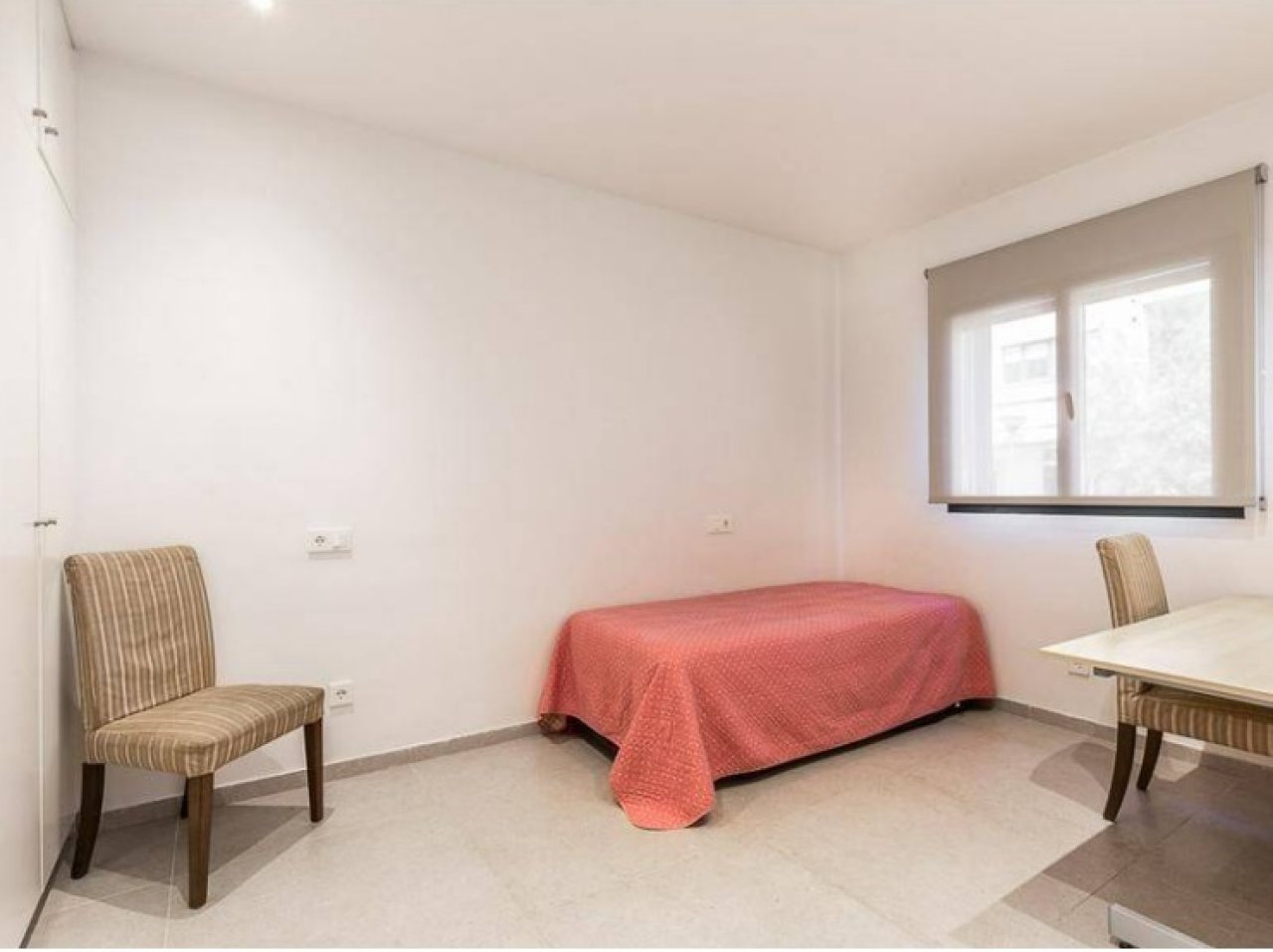 Bright room with large windows and practical layout