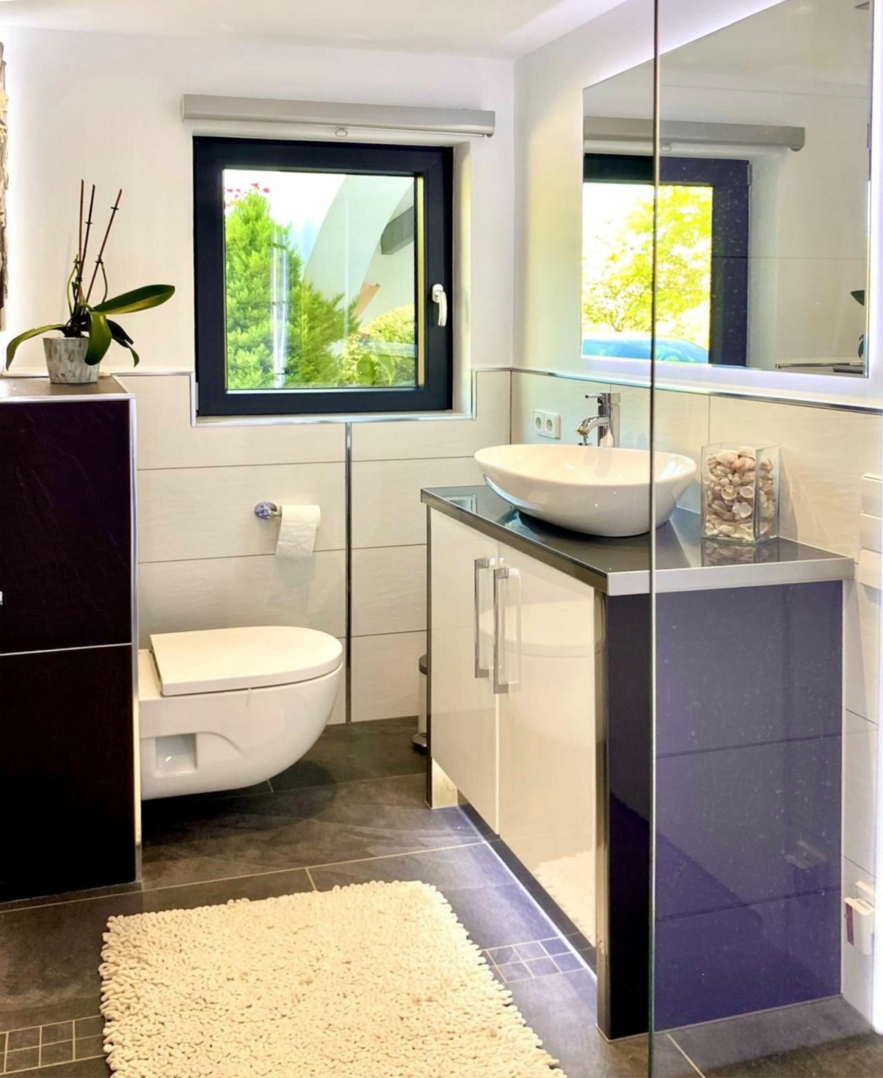 Modern bathroom with freestanding bathtub, walk-in shower, and spacious mirror area
