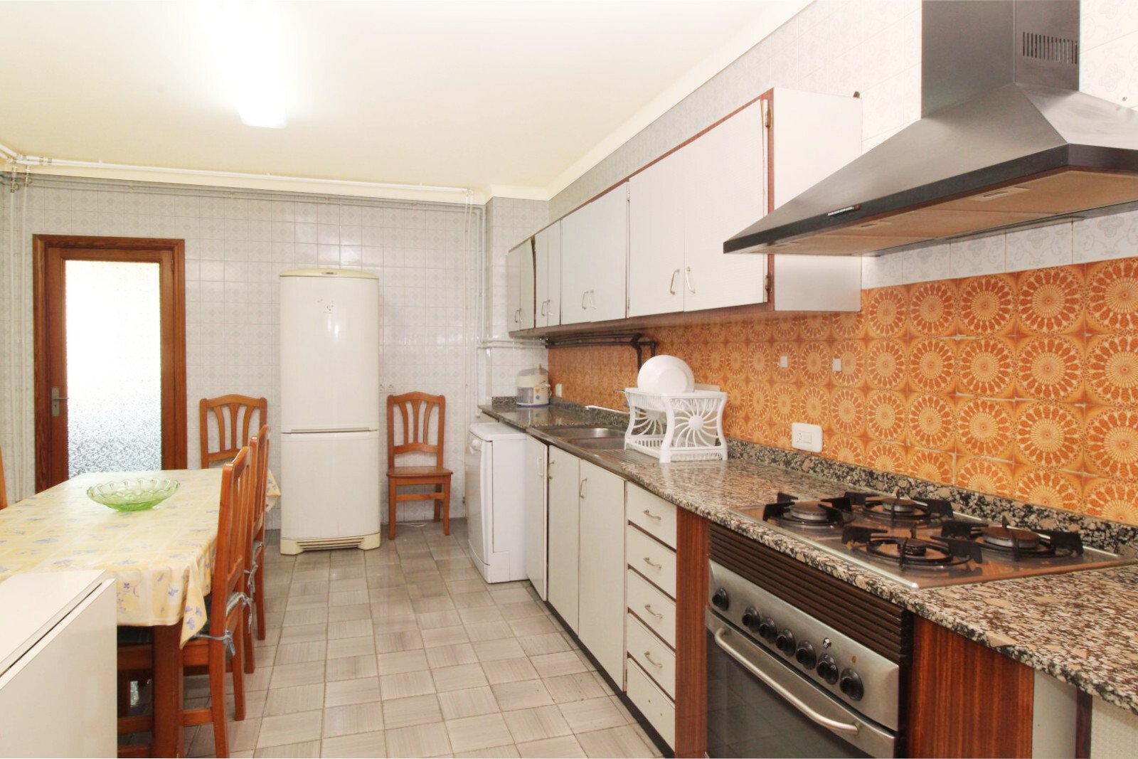 Functional kitchen with gas stove, granite countertop, and practical layout Functional kitchen with gas stove, granite countertop, and practical layout