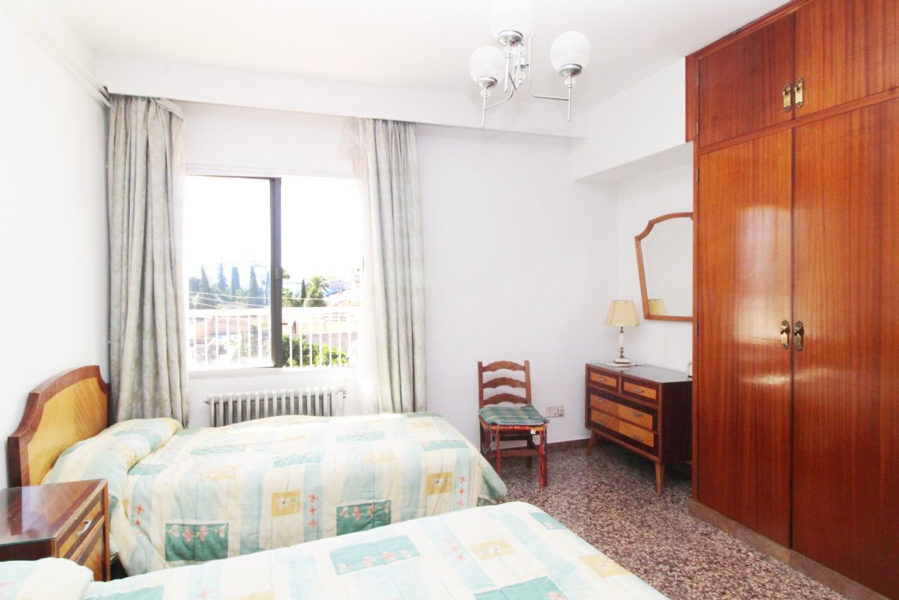 Bright bedroom with balcony access and ample storage. Bright bedroom with balcony access and ample storage.